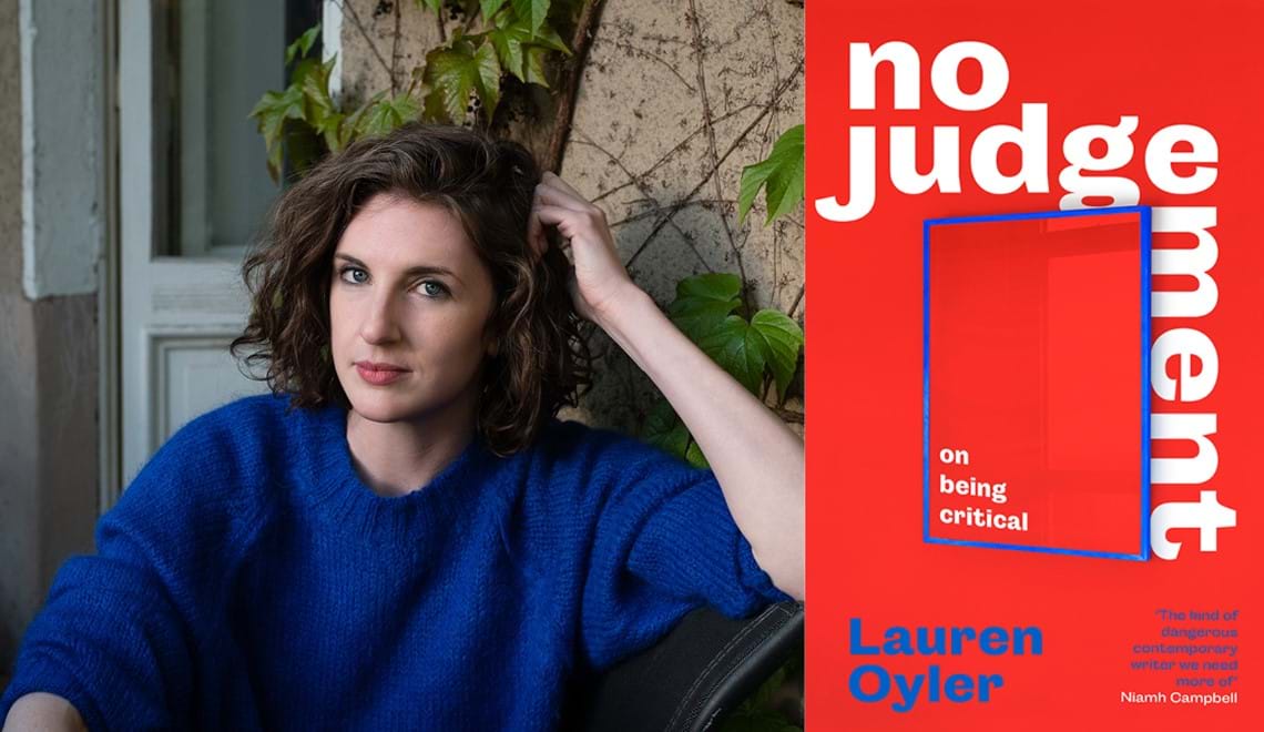 Lauren Oyler sits outdoors wearing a bright blue jumper. Lauren has shoulder length brown hair.