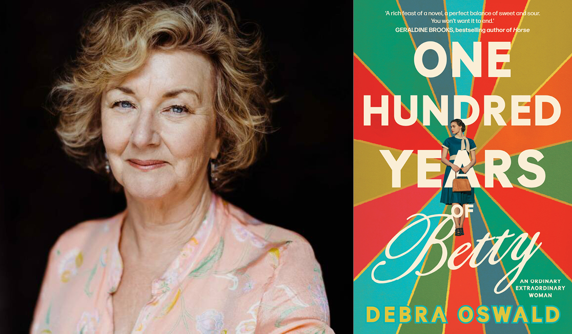 Debra wears a light pink shirt with a flower print. She has short blond wavy hair