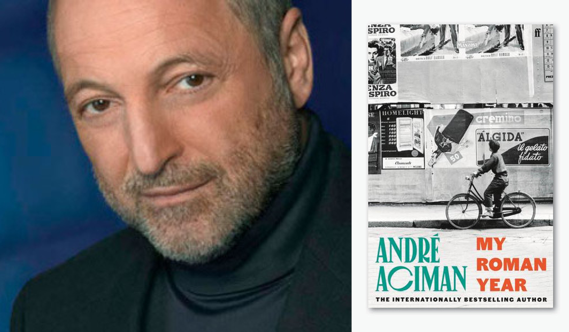 André wears a dark turtleneck and dark blazer, has a salt and pepper beard and is looking directly at the camera