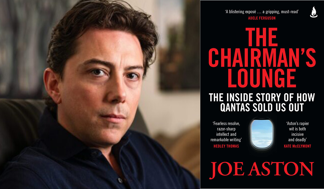 Joe wears a dark blue shirt and has short brown hair. He is looking directly at the camera