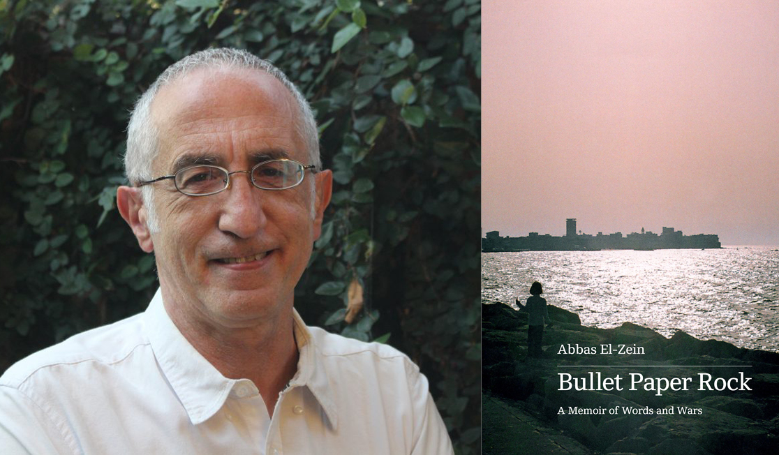 Abbas El-Zein stands in front of green foliage. Abbas wears a white shirt and glasses and has short grey hair. Abbas is smiling.